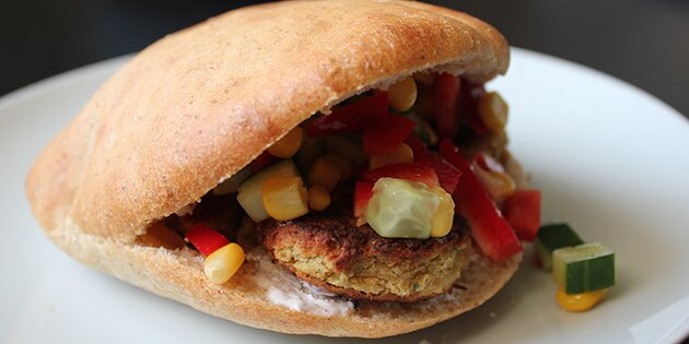 Her er pitabrødene serveret med salat og falafel.