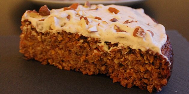 Et lækkert stykke gulerodskage med frosting.