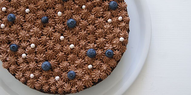 Chokoladecremen sprøjtes ud i små dutter og pyntes med friske blåbær.